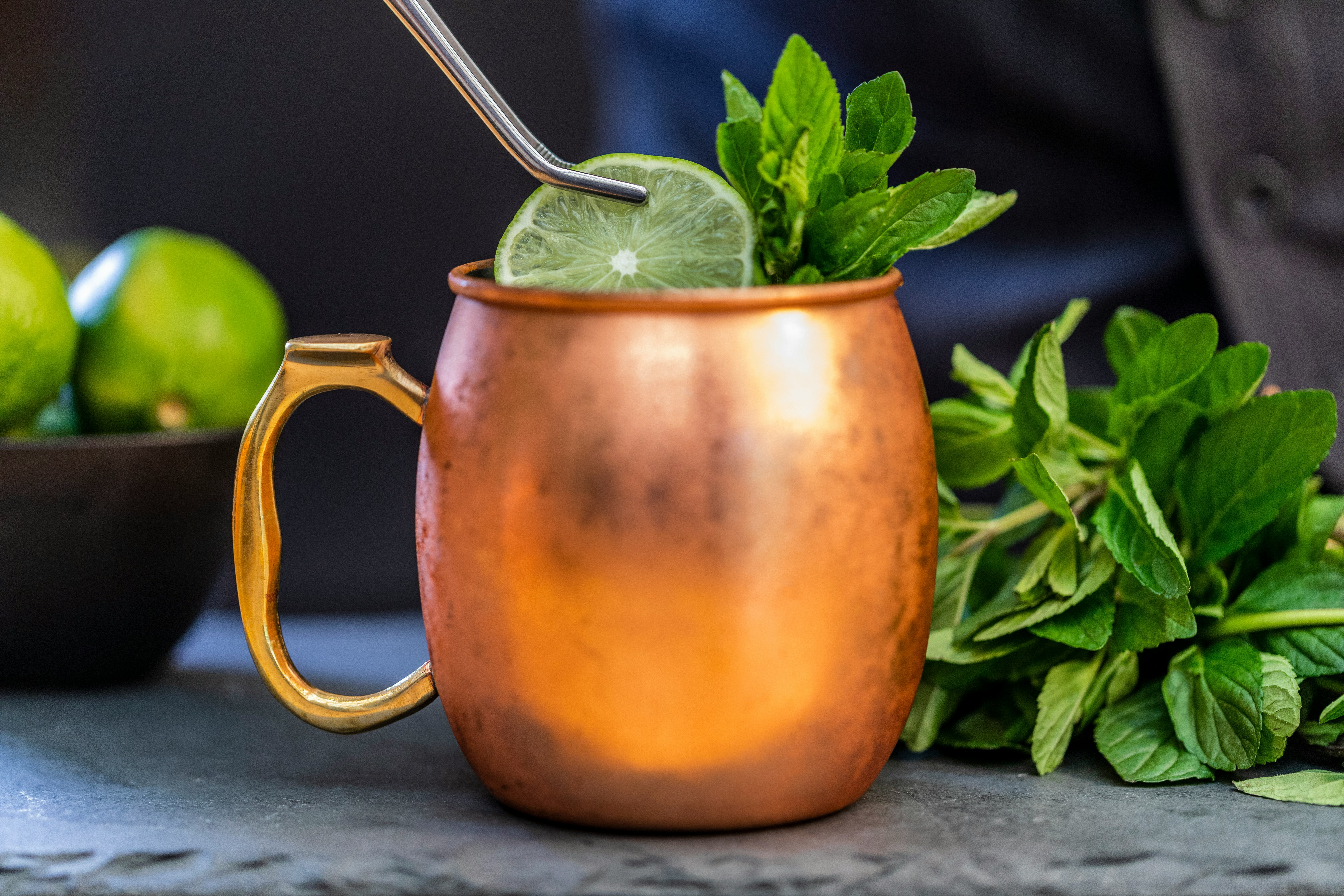 Ice cold moscow mule mug garnished with lime and mint