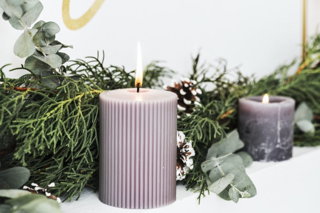 lavendar candles on mantle with greenery