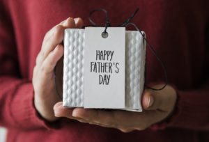 Someone holding a fathers day gift in white