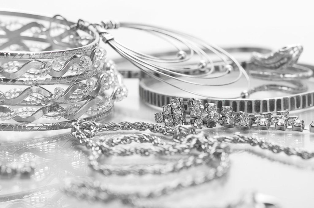 Silver and diamond jewelry in a pile