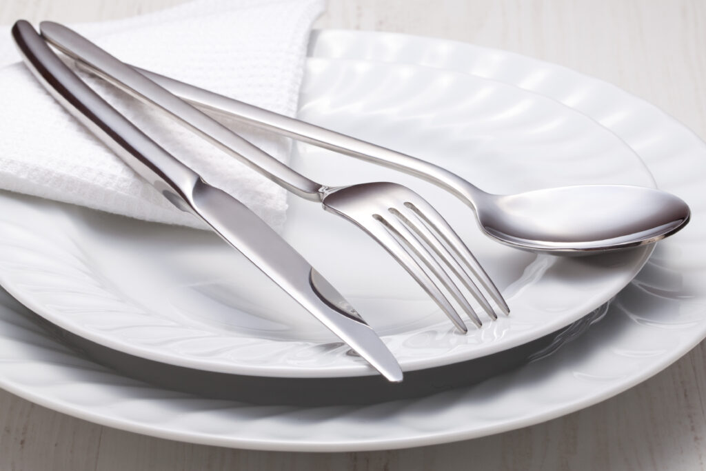 Fork, Knife, and spoon on white china dishes