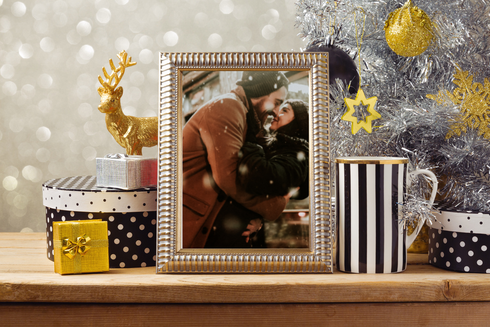 picture frame with couple embrace on table with other gifts