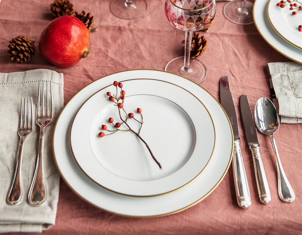 Place setting on red tablecloth with christmas decorations