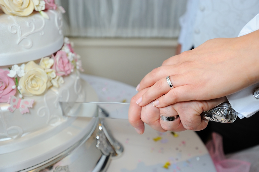 Bride and groom cutting wedding cake