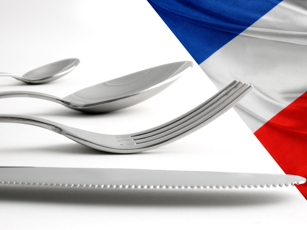 flatware tines, bowls, and blade with french flag in the background