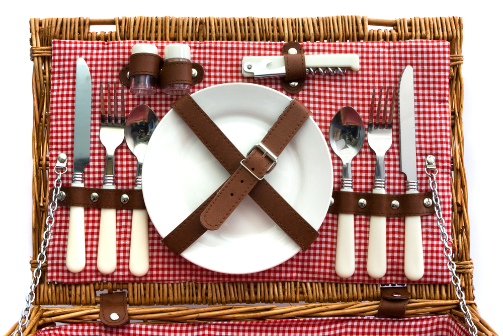 Flatware and china in a picknick basket