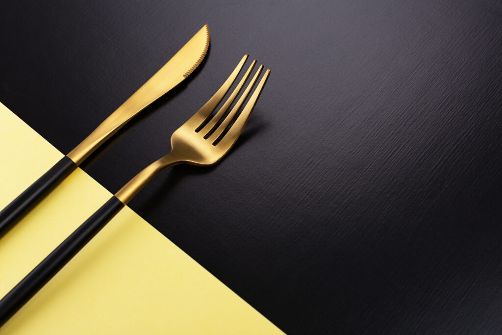 Black and Gold Two-tone flatware on a black and gold table