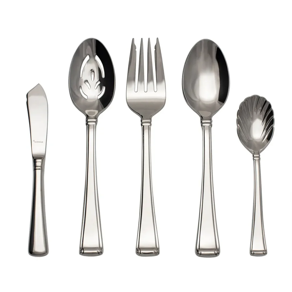 A shiny, mirror finished, 5pc flatware serving set by Gorham on white background.