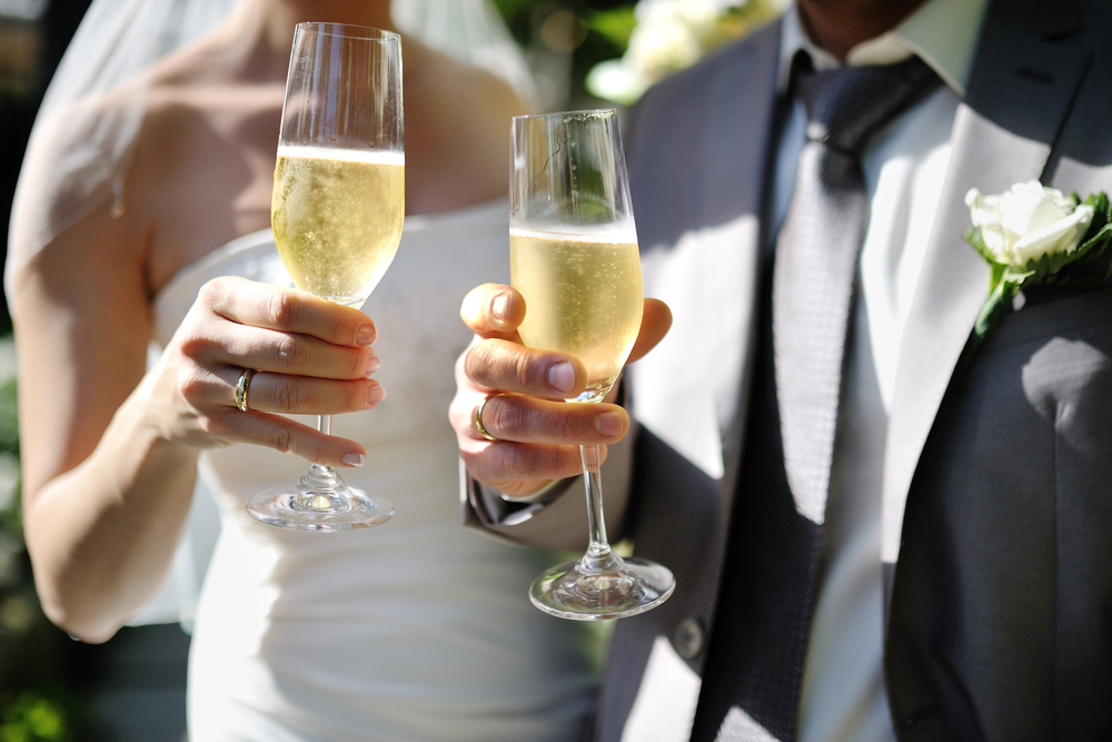 bride and groom toasting with champagne