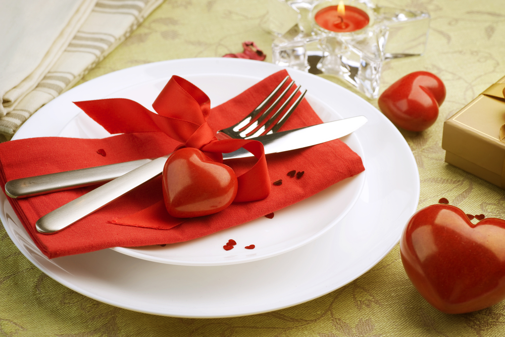 White china with flatware and red hearts and napkins