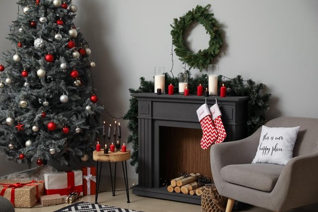 Fireplace adorned with red and white stockings and candles