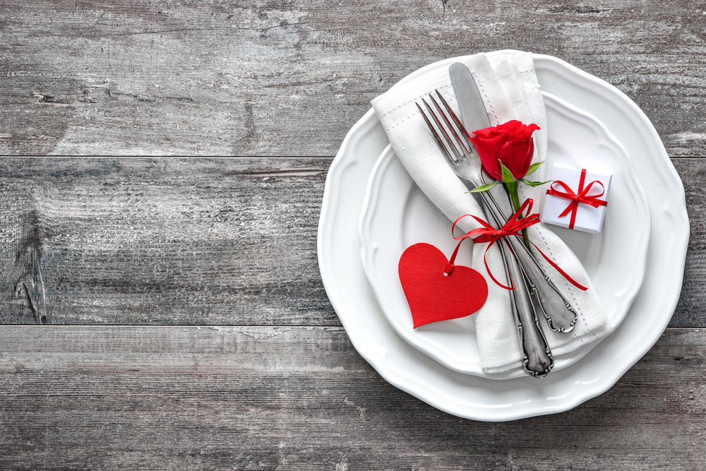 White dinnerware with red rose, heart, and present