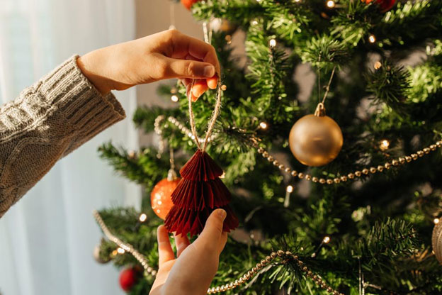 A woman decorating the christmas tree